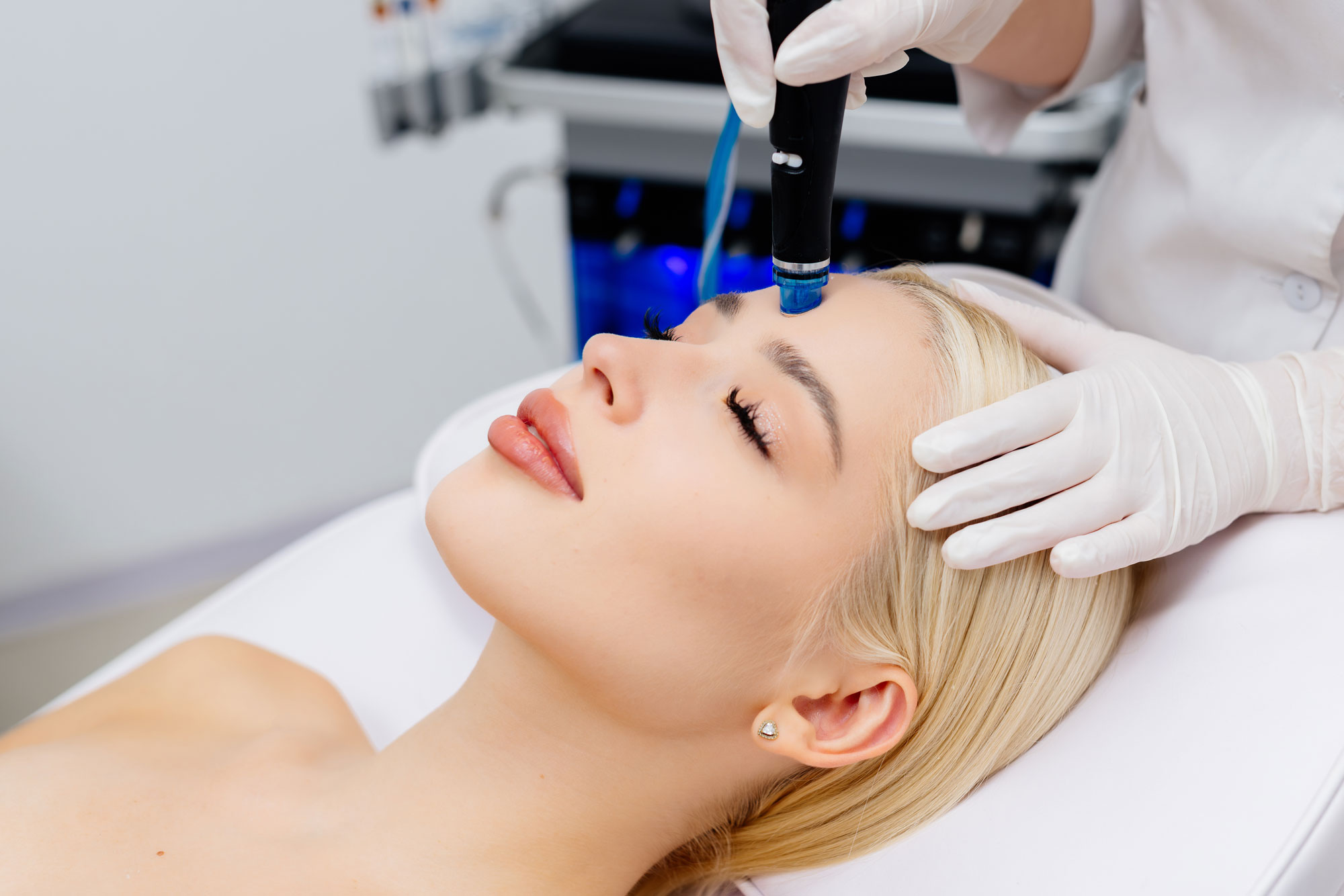 Woman receiving a HydraFacial treatment, illustrating the topic of how often to get a HydraFacial.
