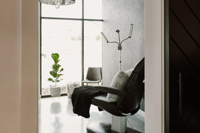 A cozy, private seating area with chairs and large windows bringing in natural light