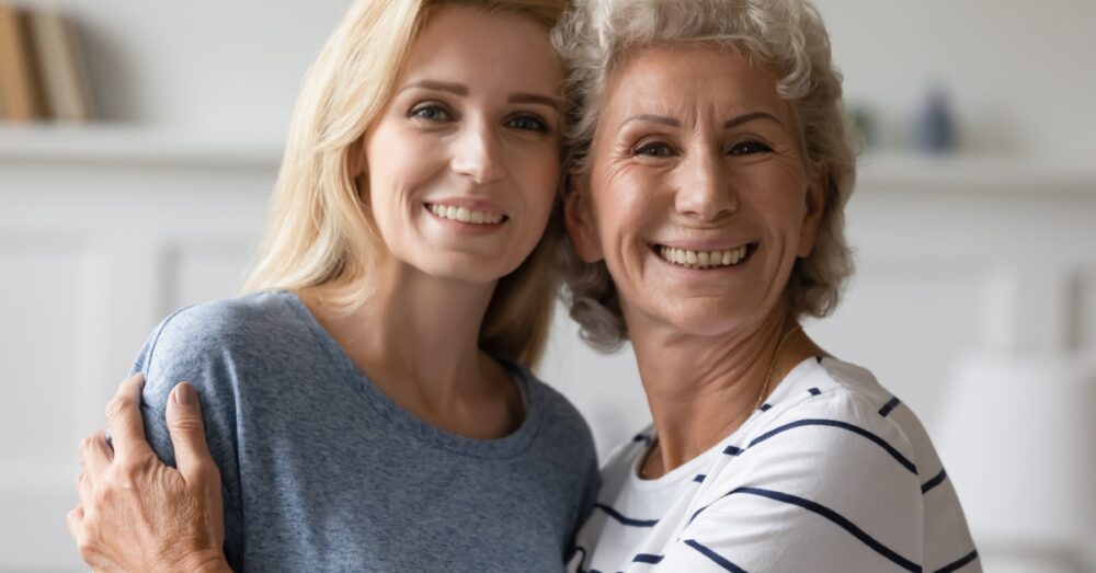 Two women hugging while smiling