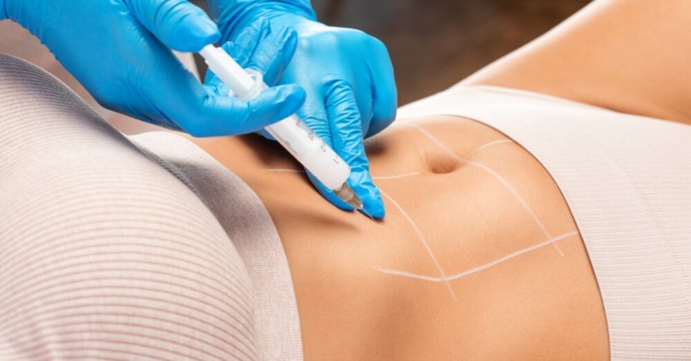 Provider in gloves administering an injection to a female’s abdomen
